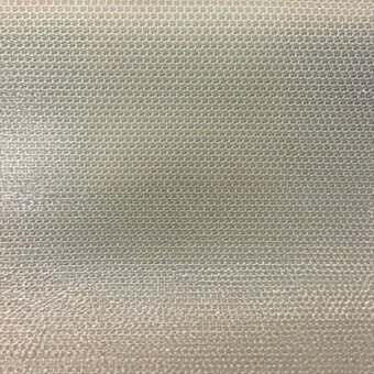 Beige woven fabric texture displaying a dense, plain weave with a matte finish and consistent thread width in a grid-like pattern.