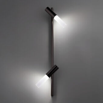 Wall lamp, dark bronze finish, slender vertical rod with two adjustable cylindrical heads and bright white oval light sources.