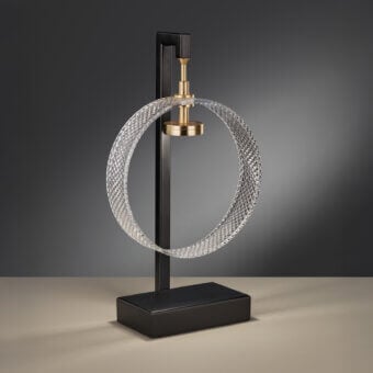 Suspended table lamp, textured glass shade, brass fixture, black metal stem, rectangular base, modern minimalist design, studio lighting.