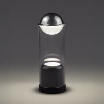 Elegant Euroluce Theorem table lamp in dark gray and transparent borosilicate glass with a rotating inner sphere