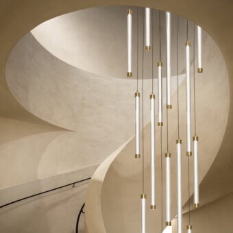Elegant Euroluce Trama suspension lamp crafted in Italy with a slender glass tube and polished gold-toned metal accents