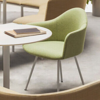 Superior Lapalma Edit armchair with rounded organic form upholstered in light green textile and satin light gray powder-coated steel base