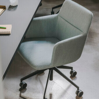 Elegant Lapalma Foil office armchair upholstered in light grey-green fabric with dark grey powder-coated aluminium swivel base