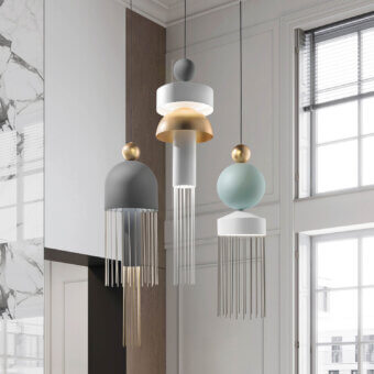 Masiero Nappe suspension lamps, brass and gold finish, spherical and cylindrical shapes with cascading rods in a modern interior.