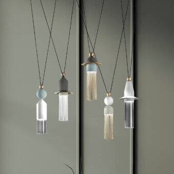 Distinguished Masiero Nappe suspension lamp with vertically elongated forms crafted in painted metal, Pyrex rods, and brass-colored accents