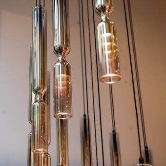 Distinguished Penta Misty suspension lamp crafted in double glass with a metallic core and golden-amber transparent finish