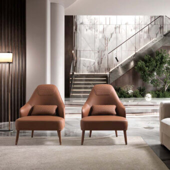 Distinguished DV Home Collection Manhattan lounge chair with solid wood frame and luxurious reddish-brown leather upholstery with satin finish legs