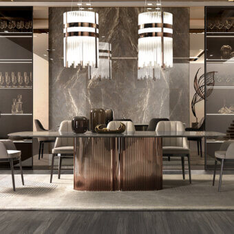 Windsor Lounge Table, grey marble top, ribbed dark metal base, surrounded by eight grey fabric dining chairs, cylindrical pendant lights.