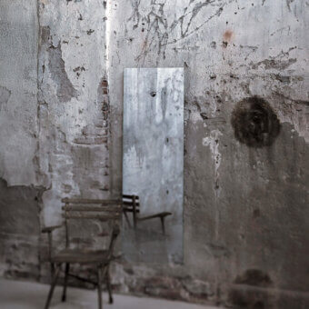 Elegant Glas Italia Fiction mirror crafted in extralight glass with degrading shaded silvering and muted gray frame