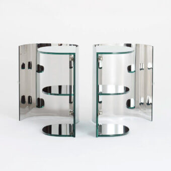 Elegant Glas Italia Oltralpe nightstand crafted in laminated and curved tempered mirrored glass with polished metal supports