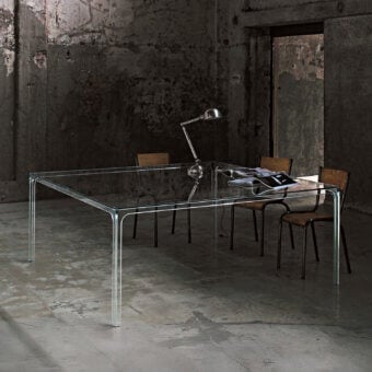 Distinguished Glas Italia Oscar table with transparent tempered glass and sleek silver-grey metal base exhibiting architectural presence
