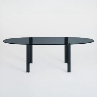 Distinguished Glas Italia X-T Oval table with smoky gray glass tabletop and subtly textured metal legs built in mirror-polished stainless steel