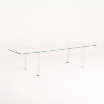 Distinguished Glas Italia X-T rectangular table crafted with transparent glass and mirror-polished stainless steel details in a clear finish