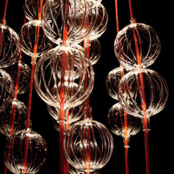 Distinguished melogranoblu Hydra - Lambda suspension lamp with fifteen hand-blown glass pendants and vibrant red metallic cords crafted in Italy