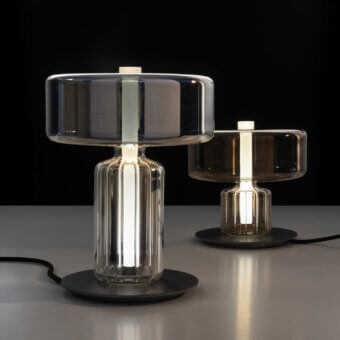 Captivating melogranoblu Rapanui table lamp with pale grey-blue hand-blown glass and steel gold finishes offering warm illumination
