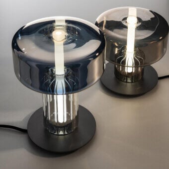 Distinguished melogranoblu Rapanui table lamp with hand-blown glass in deep blue-grey and refined gold and steel finishes