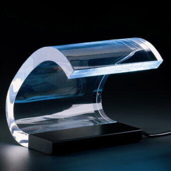 Pioneering Oluce Acrilica table lamp crafted in transparent methacrylate with a painted steel base and glossy finish