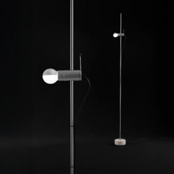 Distinguished Oluce Agnoli floor lamp crafted in neutral gray metal with a refined travertine base and innovative sliding mechanism