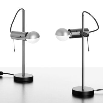 Distinguished Oluce Agnoli table lamp crafted in metal with a satin black finish and polished silver lamp head