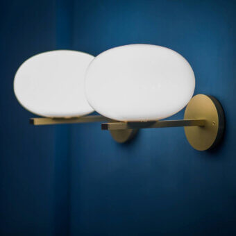 Refined Oluce Alba wall lamp crafted in Italy with satin gold-toned metal and frosted glass shades