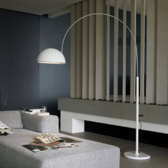Exclusive Oluce Coupé arched floor lamp with a flowing white silhouette and smooth satin metal finish