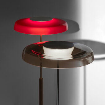 Captivating Oluce Dora floor lamp with tiered shades in red glass and golden-bronze metal, exhibiting a contemporary finish