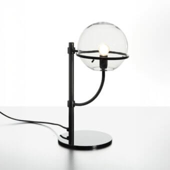 Elegant Oluce Lyndon table lamp with a sleek matte black metal frame and transparent polycarbonate sphere
