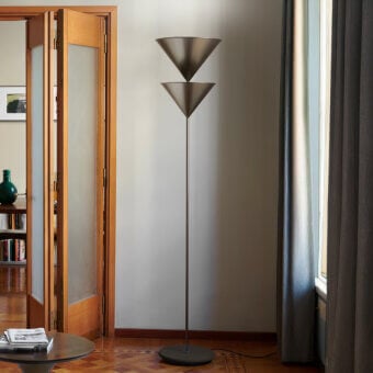 Elegant Oluce Pascal floor lamp crafted in metal with a matte dark gray finish and stacked conical shades