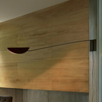Superior Oluce Plume wall lamp embodies a refined aesthetic with a dark matte finish and subtly folded shade crafted in Italy