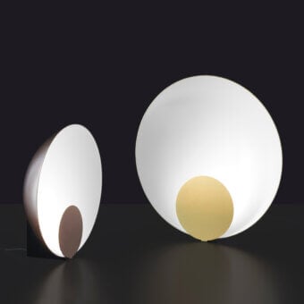 Refined Oluce Siro lamp with a semi-spherical form and warm yellow inner shade in crisp white, crafted with a matte finish