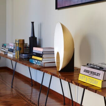 Superior Oluce Siro lamp with asymmetrical organic form crafted in gold-tone metal and smooth satin finish