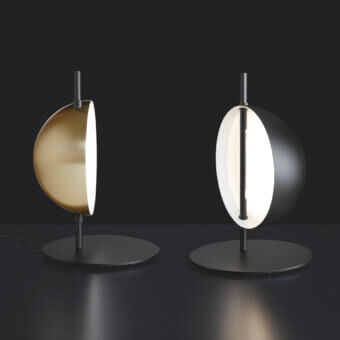 Distinguished Oluce Superluna lamp with a warm gold semi-spherical reflector and slender dark metal rod in a satin finish