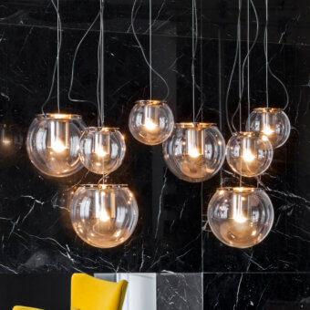 Distinguished Oluce The Globe suspension lamp in transparent blown-glass with a polished golden cylindrical metal reflector