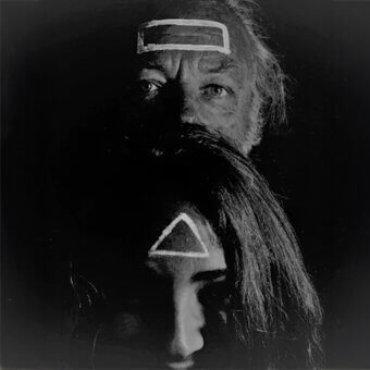 Black and white portrait of two figures with geometric white shapes on foreheads, layered composition, stark lighting, dark background.