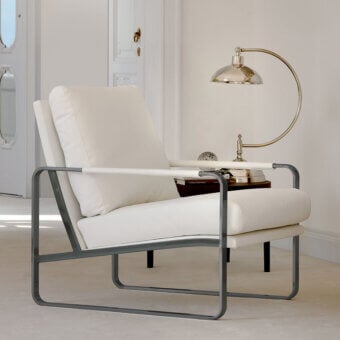 Distinctive Bontempi Clarissa lounge chair with creamy white textile upholstery and sleek dark gray matte metal frame