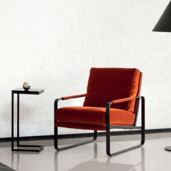 Distinctive Bontempi Clarissa lounge chair with reddish-orange textile upholstery and sleek matte black metal frame