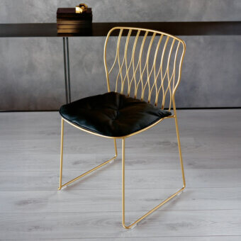 Distinguished Bontempi Freak chair with glossy golden metal frame and sleek black leather seat crafted in Italy