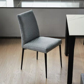 Elegant Bontempi Mila chair upholstered in black and white houndstooth textile with matte-finish metal legs