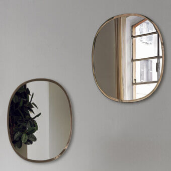 Elegant Bontempi Renoir mirror with curved oval silhouette and satin-finished muted gold-toned metal frame