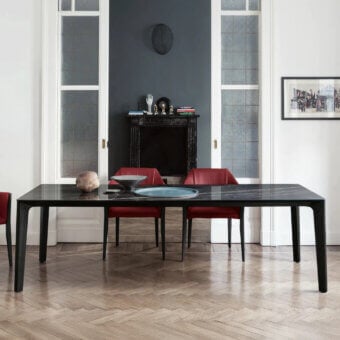 Superior Bontempi Versus table crafted with a sinuous steel frame and glossy black tabletop with grey veining