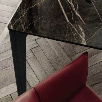 Exceptional Bontempi Versus table with polished marble tabletop and dark matte-finished wooden legs embodies contemporary elegance