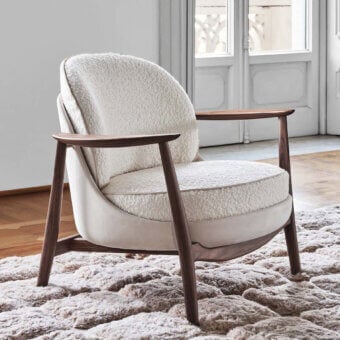 Distinguished Porada Ginkgo XL lounge chair with Canaletta walnut frame and textured off-white bouclé-like textile upholstery
