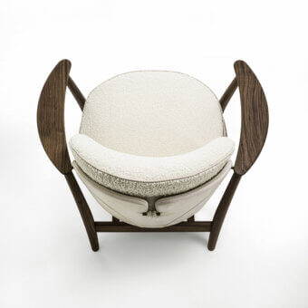 Distinguished Porada Ginkgo XL lounge chair crafted with Canaletta walnut and upholstered in textured off-white bouclé-like textile