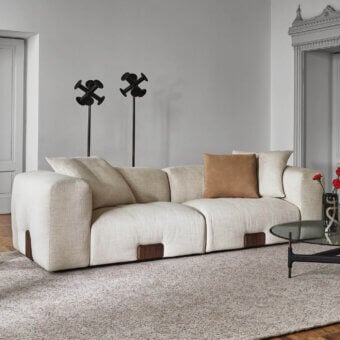Distinguished Porada Koji sofa upholstered in light beige textured fabric with Canaletta walnut detailing presents a soft rounded form