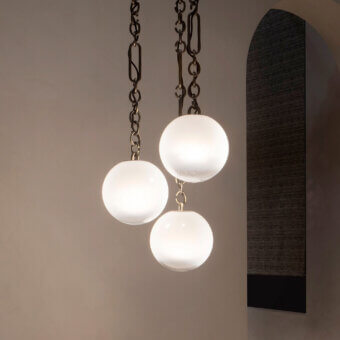 Exclusive Rugiano Collier suspension lamp with spherical white-glass diffusers and bronzed brass chain links crafted in Italy