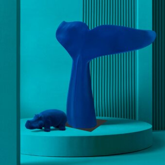 Cassoni Adriani Rossi Corsaro velvet sculpture, blue whale tail form, with hippo, on teal circular platform in minimalist setting.
