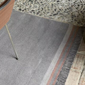 Exceptional Amini Coco rug with heathered grey and coral stripes crafted in recycled PET with a hand-clipped finish