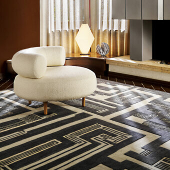 Exceptional Amini Maze rug with a black and ivory labyrinthine design hand-knotted in Tibetan wool with a clipped carved finish