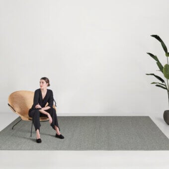 Distinguished Amini Plain rug crafted with polypropylene, viscose and polyester in a muted grey-green with a matte finish