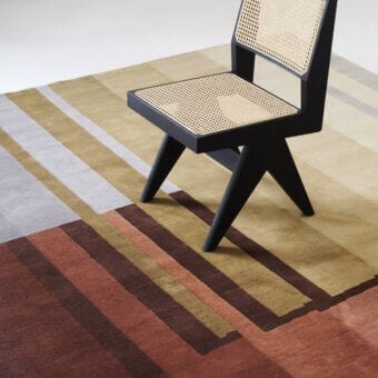 Distinguished Amini RD Braque rug hand-knotted in New Zealand wool with layered red and green stripes and a subtly textured matte finish
